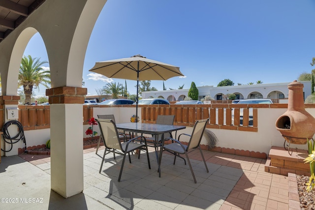 view of patio / terrace with outdoor dining space and fence