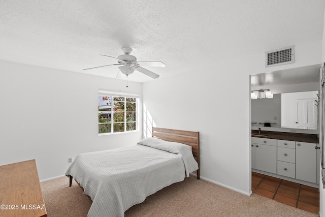 bedroom featuring baseboards, visible vents, a textured ceiling, and carpet flooring