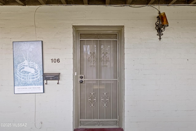 property entrance with brick siding