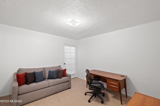 office space with carpet, baseboards, and a textured ceiling