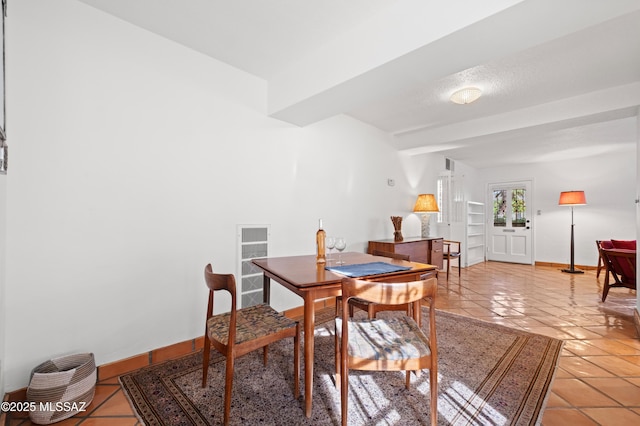 dining room featuring baseboards and light tile patterned floors