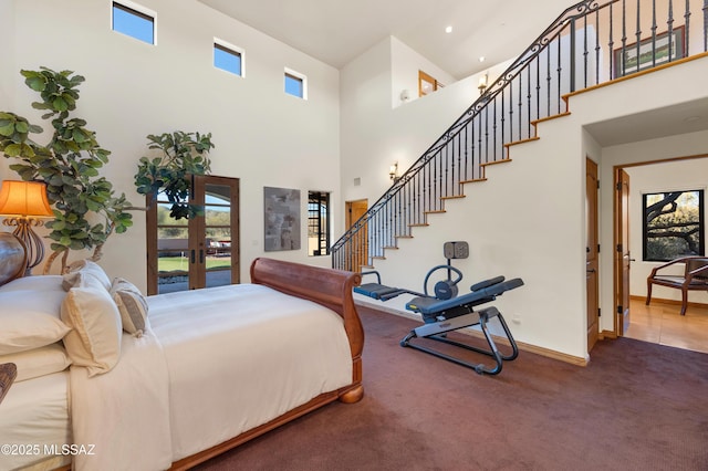 bedroom with carpet, french doors, a high ceiling, access to outside, and baseboards