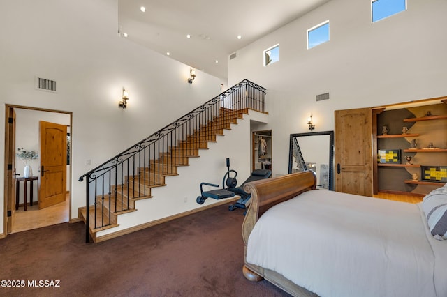 carpeted bedroom with visible vents and baseboards