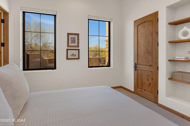 unfurnished bedroom featuring light colored carpet and baseboards