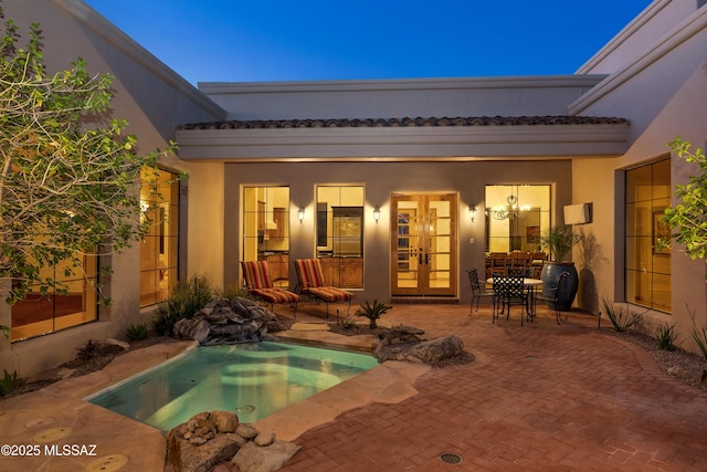 view of swimming pool featuring a patio and french doors