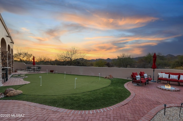 exterior space featuring a patio area, fence, and a fire pit