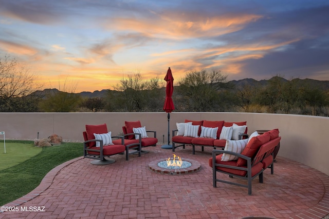 view of patio with an outdoor fire pit and fence