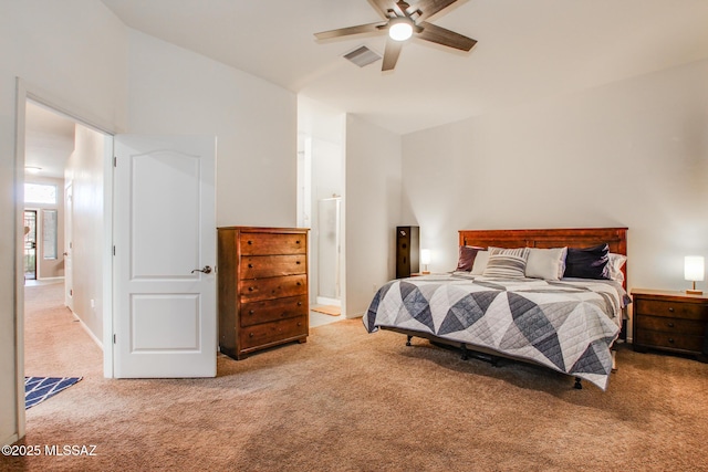 carpeted bedroom featuring ceiling fan, visible vents, and ensuite bathroom