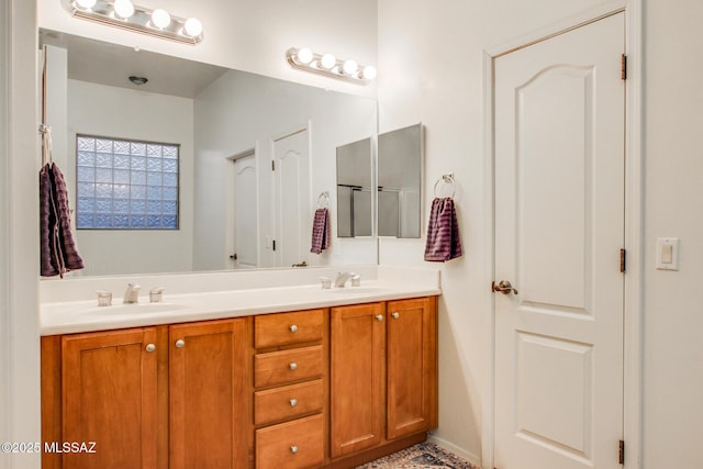 full bathroom with double vanity and a sink