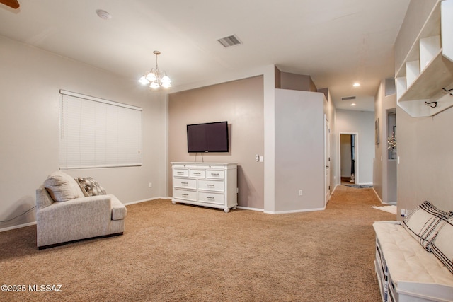 sitting room featuring a chandelier, light colored carpet, visible vents, and baseboards