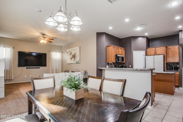 dining area with recessed lighting, light tile patterned floors, visible vents, and ceiling fan with notable chandelier