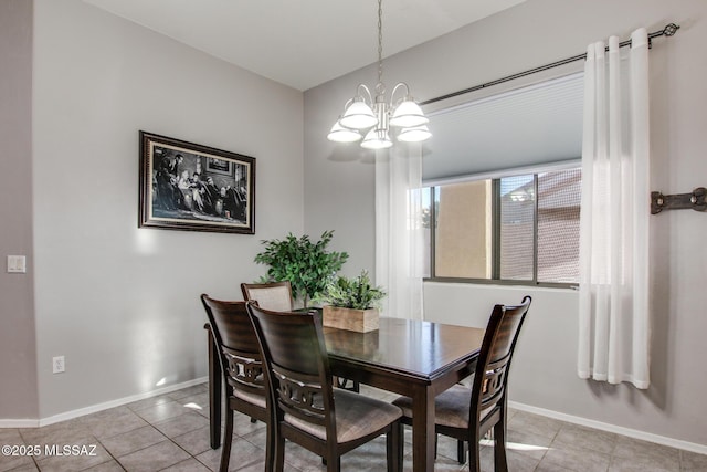 dining space featuring baseboards, light tile patterned flooring, and a notable chandelier