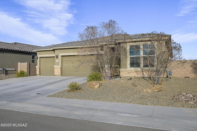 view of front of house with a garage, concrete driveway, and stucco siding