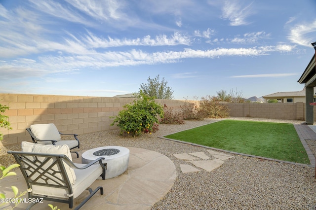 view of yard with a fire pit, a patio area, and a fenced backyard