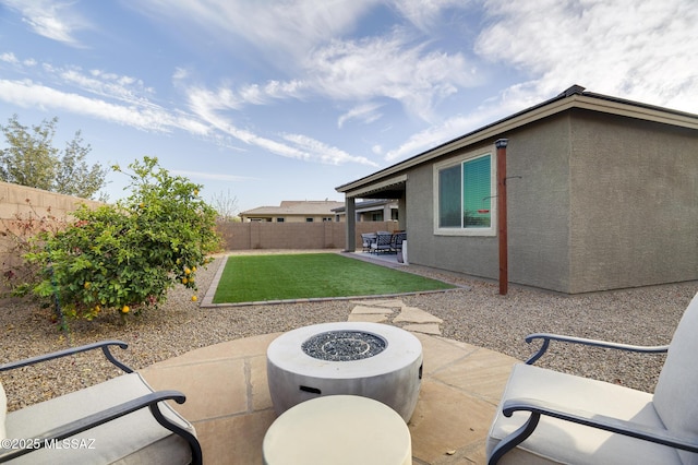 view of patio / terrace featuring an outdoor fire pit and a fenced backyard
