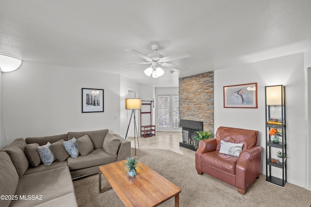 living room featuring ceiling fan, a fireplace, and french doors