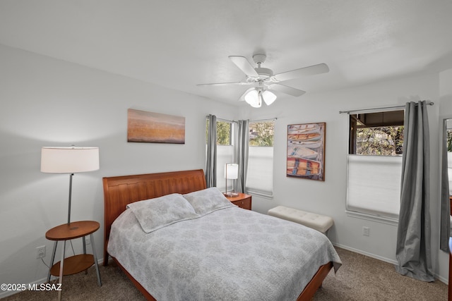 bedroom featuring ceiling fan, baseboards, and dark colored carpet