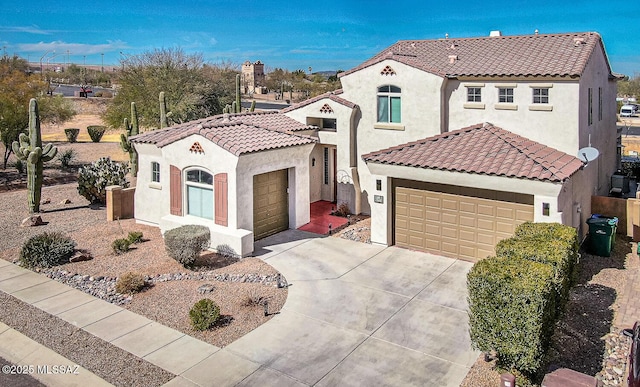 mediterranean / spanish-style home featuring a tiled roof, concrete driveway, and stucco siding