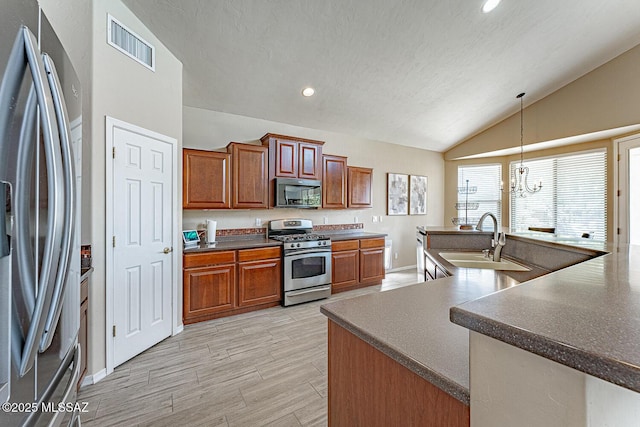 kitchen with brown cabinets, stainless steel appliances, visible vents, vaulted ceiling, and a sink