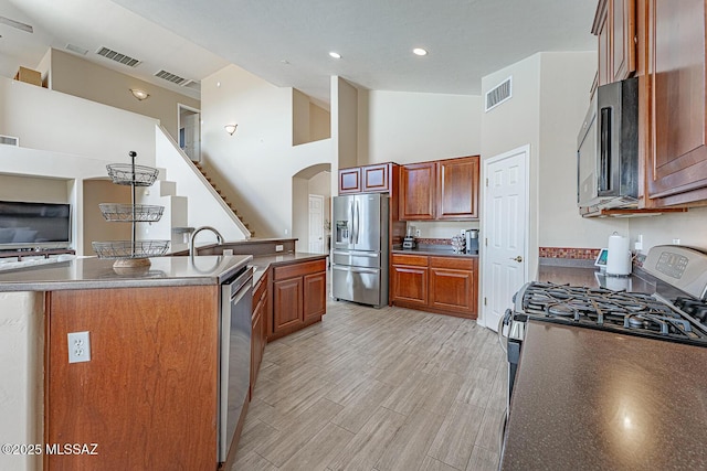 kitchen featuring a kitchen island with sink, visible vents, and stainless steel appliances