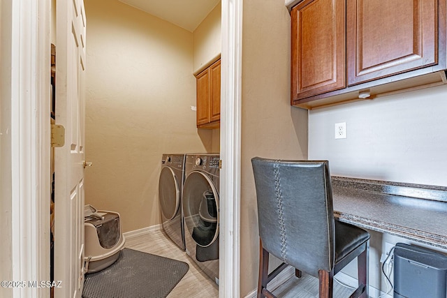 laundry room with cabinet space, washer and clothes dryer, and baseboards