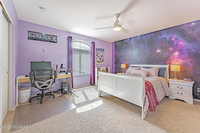 bedroom with an accent wall, ceiling fan, baseboards, and wallpapered walls