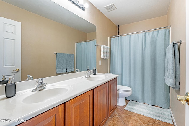 full bathroom featuring toilet, visible vents, a sink, and tile patterned floors