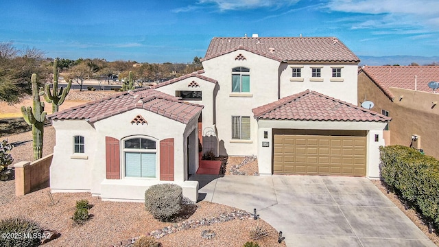 mediterranean / spanish home with an attached garage, stucco siding, driveway, and a tiled roof