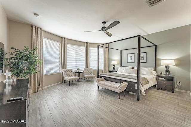 bedroom featuring ceiling fan, baseboards, visible vents, and wood tiled floor