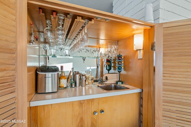 bar with indoor wet bar and a sink