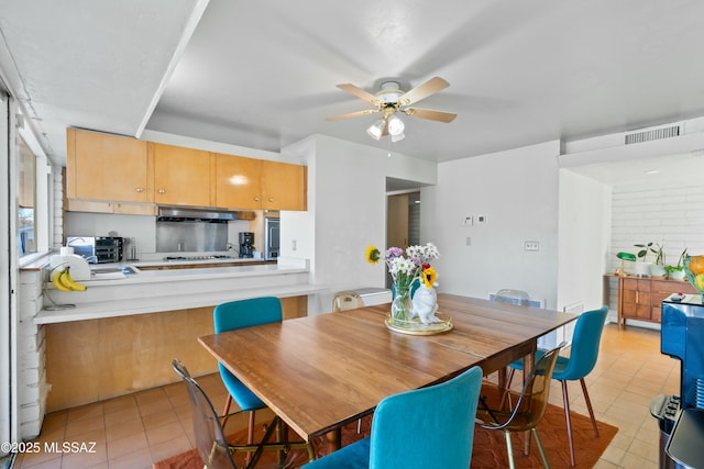 dining room featuring light tile patterned flooring, visible vents, and a ceiling fan