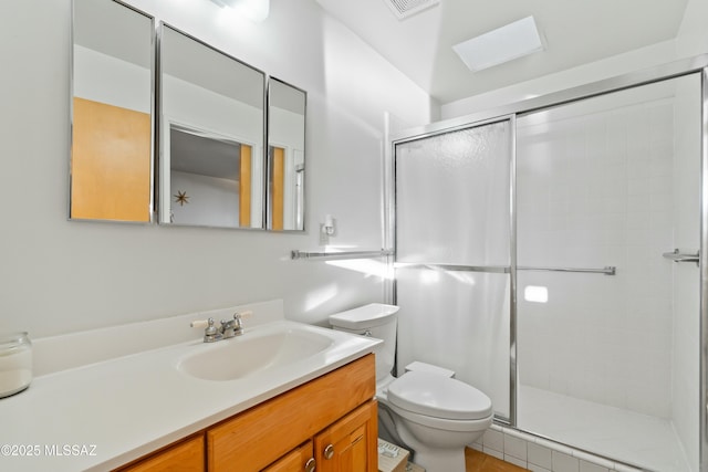 full bath featuring toilet, a stall shower, and vanity