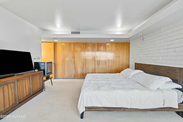 bedroom featuring visible vents and light carpet