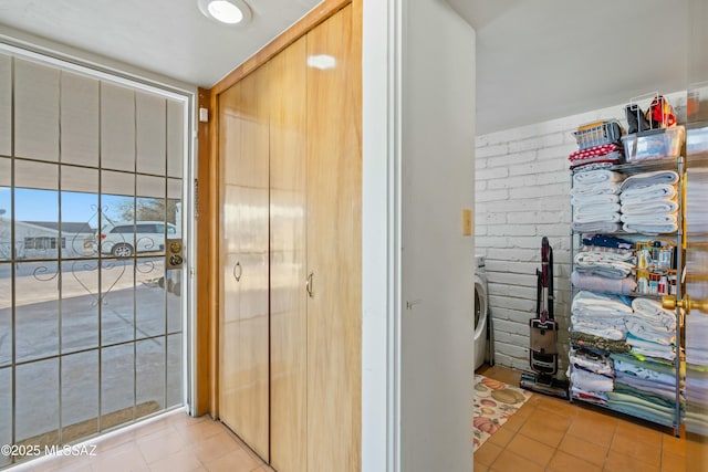 interior space with washer / dryer and light tile patterned flooring