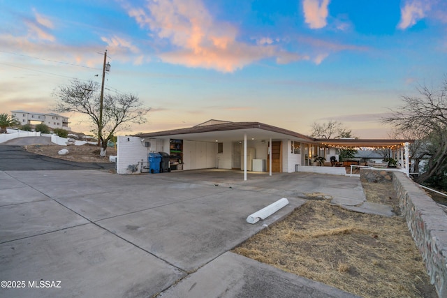 view of front of property with a carport and concrete driveway