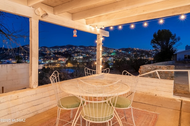 patio at night featuring outdoor dining area