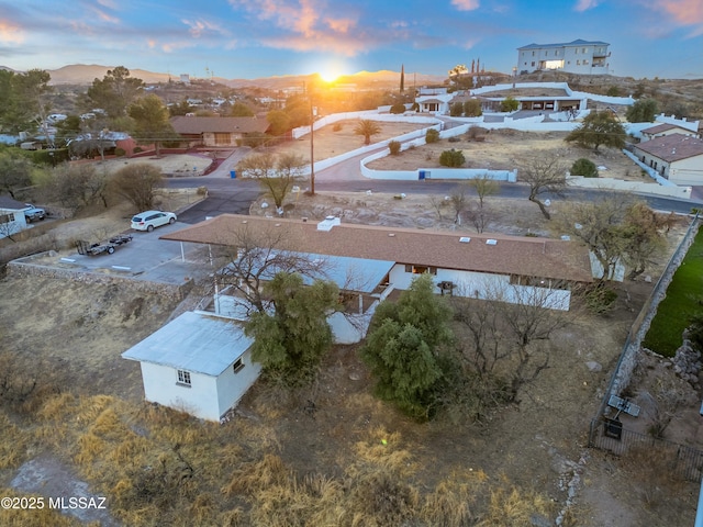 aerial view at dusk featuring a residential view