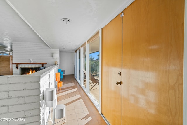 hallway with light tile patterned floors and floor to ceiling windows