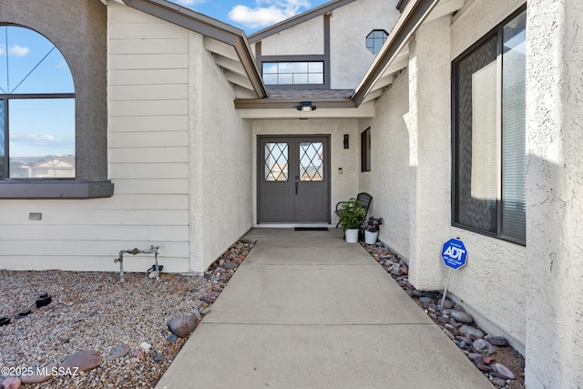 entrance to property with stucco siding