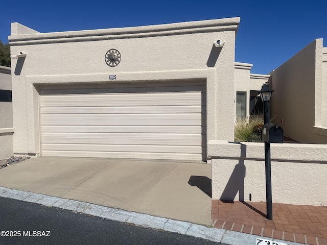 garage featuring concrete driveway