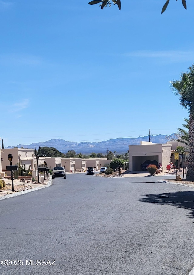 view of road with curbs and a mountain view