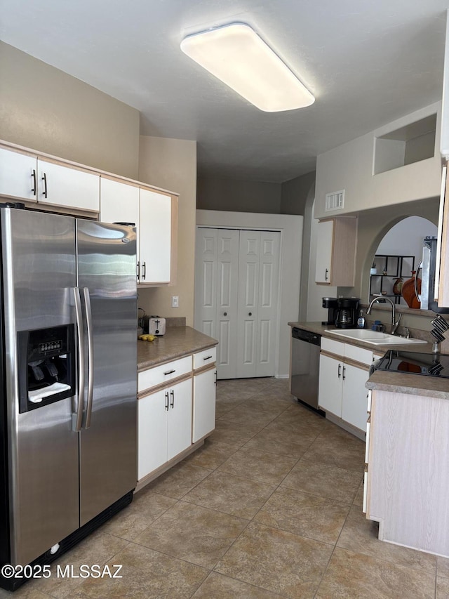 kitchen with white cabinetry, visible vents, appliances with stainless steel finishes, and a sink