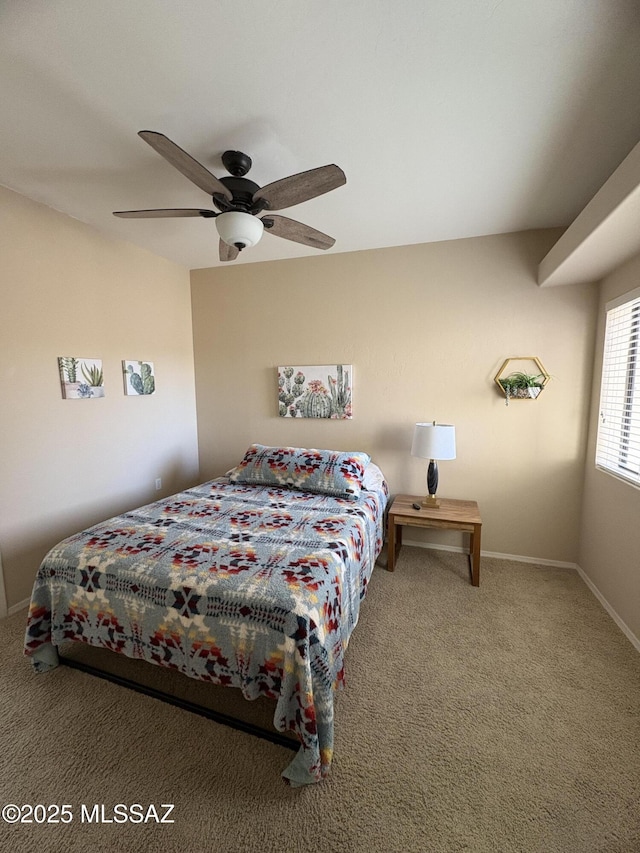 carpeted bedroom featuring ceiling fan and baseboards