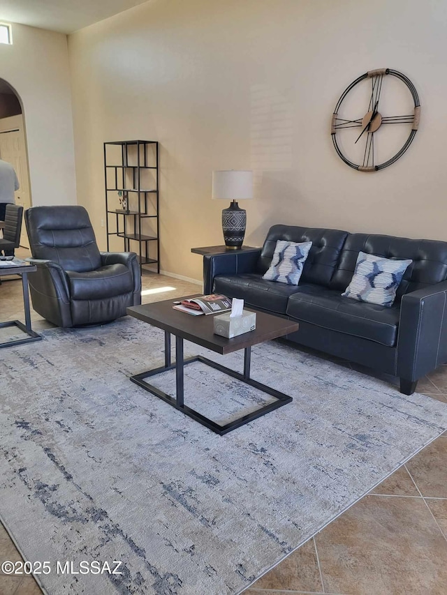 tiled living area featuring arched walkways