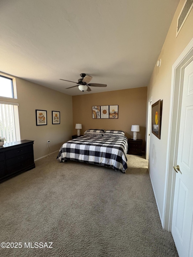 carpeted bedroom with ceiling fan, visible vents, and baseboards