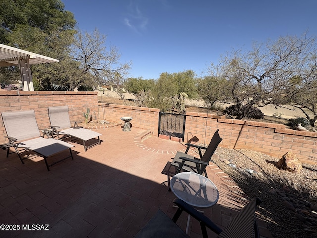 view of patio with fence and a pergola