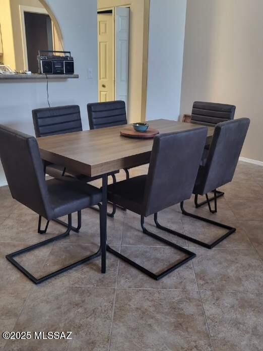 dining space featuring baseboards