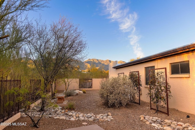 view of yard with a fenced backyard and a mountain view