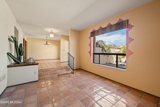 empty room with an inviting chandelier and light tile patterned flooring