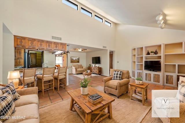 living room featuring light tile patterned floors, visible vents, and a wealth of natural light